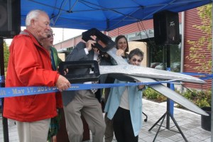 Island Transit Executive Director Martha Rose uses a large pair of scissors to cut the ribbon and officially open the new facility May 17.