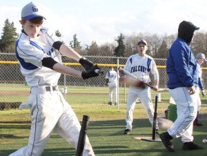 Colton Sterba slugs off a tee at practice. He will be one of a dozen Falcons in rotation at pitcher.