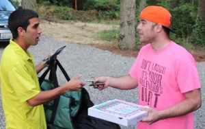 Quinn Broyles tips D-Up delivery driver Sam Nelson for bringing him a pie from Joe's Wood-Fired Pizza in Bayview.