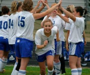 Excitement is high as Falcon Gwen Bakke emerges from a tunnel of her teammates as South Whidbey’s game against the Cedarcrest Red Wolves gets underway Thursday.