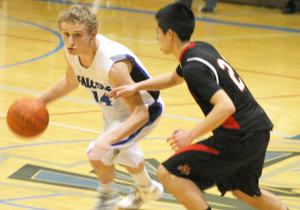 Sam Lee turns the corner against Wildcat senior guard Alex Tapert on Tuesday night. The Falcon senior scored six points