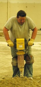 Job-site foreman Terry Price operates his jackhammer last week as work progresses on The Goose Community Grocer at Bayview Center.