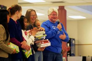 Middle school teacher Rachel Kizer loads owner Jill Campbell and her crew at Island Recycling with Box Tops for Education items and books that were purchased with that money during the Parent Teacher Association awards May 3.