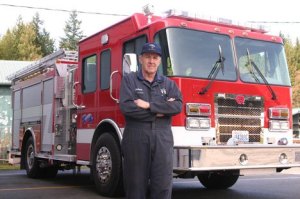 Island County Fire District 3 maintenance chief Michael J. Cherry shows off one of the district's two new pumper trucks at the Bayview Fire Station on Monday. 'It's the best thing we've ever done