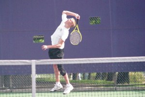Riley Newman springs for his serve against Jimmy Do in the first round of the WIAA 2A state tennis boys singles tournament. Newman won the match 6-1