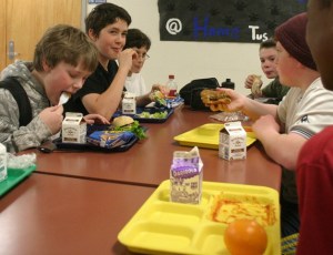 Russell Daly feasts on a roast beef sandwich during lunch at Langley Middle School. To his left are Maxwell Dodd and Jadan White. Across the table are Michael Maddux and Brent de Wolf. All sixth-grade students eat lunch together after a brief trial at school-wide lunches much of this school year. Food service may change next year.