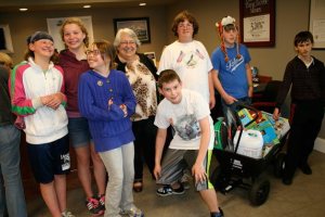 A handful of kids cart and carry the raffle winnings