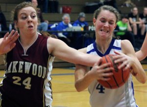 Falcon junior Kristen Schuster secures a rebound from Lakewood junior Brooklyn Hammond in a Cascade Conference girls basketball game Friday