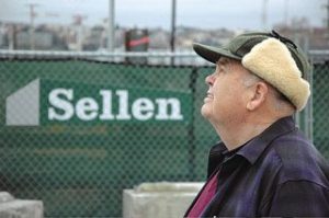 John Carty on a Gates Foundation construction site near the Space Needle in Seattle on his birthday this past January. His family arranged a banner high on the crane that read “Happy 75th John Carty.”