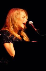 Nancy Nolan performing at the piano.