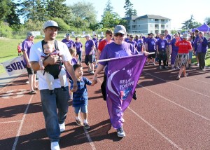 Christine Eborda and her family walk the survivor’s lap together. Eborda was diagnosed with cancer when she became pregnant with her infant son. Today she’s cancer free.