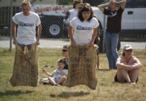 Christine Johnson edges out Cassie Bosman to win the sack race during the games on July 4 at the Maxwelton Parade.