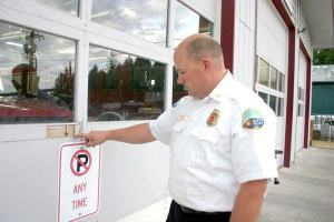 Jon Beck examines sunken screws in the bay door at South Whidbey Fire/EMS Bayview station. Asbestos was recently discovered in the ceiling and walls