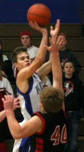 Falcon senior Taylor Simmons launches a shot over Coupeville senior Caleb Valko on Thursday night.