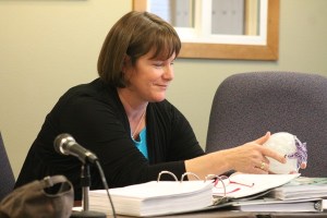 Langley City Councilwoman Margot Jerome inspects a piece of blown-glass art given to her from the city at her last council meeting May 20.