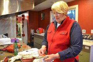 Barbara MacCallum stitches on a nose for her snowman pillow at Eddy’s Repurposed in Freeland. MacCallum is one of the crafters featured at the pop-up store.