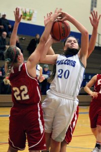 Falcon freshman Megan Drake is fouled as she drives to the hoop against King’s sophomore Anna Parker in the fourth quarter of the girls basketball game Jan. 21.