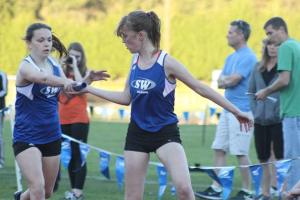 South Whidbey senior Kendra Warwick hands off the baton to senior Allie Vanbenschoten during the Falcons’ three-way home meet March 31. Warwick