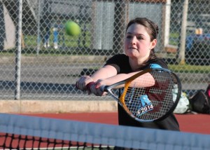 Brea Gauger tracks a shot for a backhand volley at the net during practice.