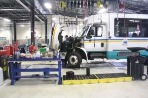 A mechanic works on an Island Transit bus parked in the new 34