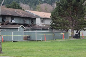 The remains of Navy housing in Oak Harbor sits secured behind fencing. It was destroyed by fire this past Sunday. Authorities believes it’s the work of an arson