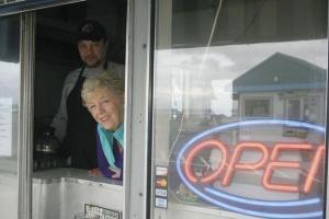 Shirley Wilson of Shirley’s Kitchen watches for potential customers at the Clinton ferry dock Monday. The snack shack boasted booming business over the weekend