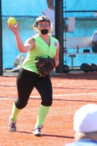 Bella Northup fields a ball and throws out a runner against the Bellevue East/Bellevue Thunderbird/Mercer Island Little League juniors division team on Sunday