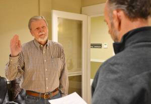 Ed Halloran is sworn in by Port of South Whidbey Commissioner Curt Gordon at a special meeting Tuesday