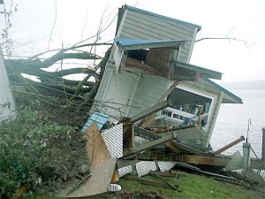 The summer home owned by Morgan and Laurie Bartlett is considered a total loss as the landslide pushed it off its foundation
