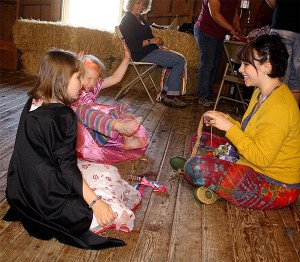 Amelia Deal and Annie Wheat do crafts with Meadow Holtby at the PRIDE parade fundraiser June 5 at the Greenbank Farm.