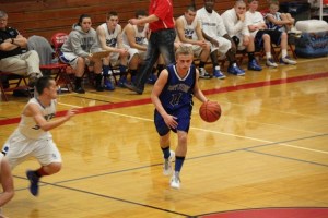 Falcon senior point guard Sam Lee brings the ball to the top of the key against Central Linn on Saturday.