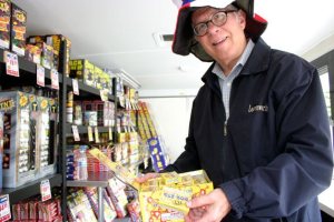 Bob Welch displays the popular TNT “pop its” fireworks at the South Whidbey Kiwanis stand in Clinton.