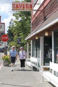 Dann and Jincey Jergenson of Langley walk past Dog House Tavern on First Street. Other than advertising that can be seen through the window