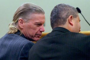 Accused murderer James Huden sits next to his attorney