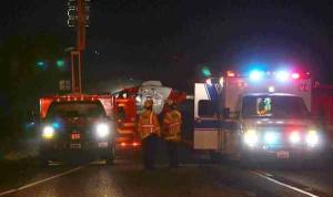 South Whidbey Fire/EMS firefighters watch as an air ambulance takes off from Highway 525 near Coles Road with one patient.