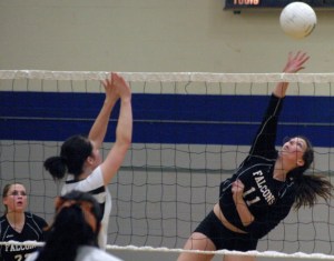 Falcon senior middle hitter Hannah Calderwood leaps for a kill over Tiger senior Kayla Mathis. Calderwood led the Falcons with 12 kills and six blocks on Thursday in South Whidbey’s 3-2 win.