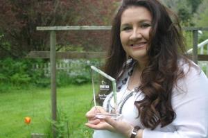 Suzanne Kelman holds up her “Best Feature Screenplay” award which she received from the Los Angeles United Film Festival for her script “Maggie the Brave.” The script is currently being financed for development by MovieHatch.com.