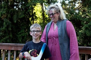 Liam Dow (left) is all smiles with boomerang in hand and mom