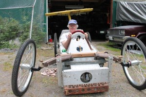 Phil Simon sits in the near-finished car that he’ll drive Sunday during the Soup Box Derby in Langley.