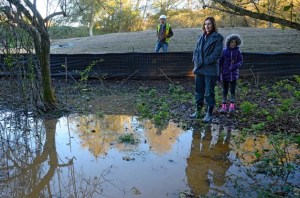 Freeland property owner Minda Wicher and her daughter inspect flooding on their land earlier this week. Wicher says the water is result of Sunny View Village