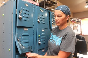 Lani Bryant inspects an employee locker at Freeland Cafe which was pried open when a burglar broke in and stole a change bag.