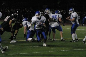 Austin Bennett looks downfield for blockers against Cedarcrest High School. The Red Wolves won their homecoming game 31-20.  South Whidbey led 14-0 in the first quarter after Bennett scored on a 12-yard run. The loss dropped the Falcons’ record to 3-4.