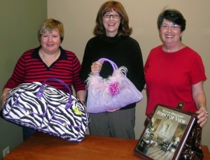 Soroptimists Lisa Grosso holds a travel bag