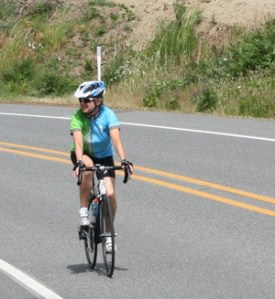 A bicyclist treks along Bayview Road during a recent sunny day. Island County wants to have a bike trail from the bridge to the ferry.