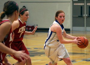 Falcon junior point guard Madi Boyd swings the ball as she looks to pass in the fourth quarter against King’s on Friday night. Lady Knights seniors Madison Shinn and Ellie Rasmussen defend the interior.