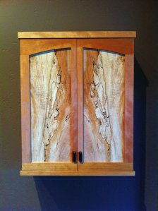 Furniture maker Rob Hetler made this 'Memory Box' to hold cremated ashes for a loved one.  The piece is on display with the work of 19 other master woodworkers through Oct. 3 at Woodpalooza in the Bayview Cash Store.