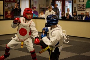 Waylan Parsell blocks Tyler King’s kick during Tiger Martial Arts 10th anniversary tournament on March 21 in Freeland.