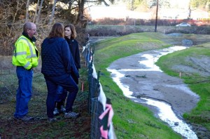 Island County Public Works Director Bill Oakes and Commissioner Jill Johnson speak with Minda Wicher on a tour of her property