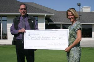 Kimmer Morris accepts a check from Bill Davis