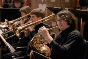 South Whidbey High School Jazz Ensemble members Seth Sobottka on French horn and Casey Fate and Liana Cave on trombone swing